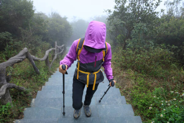 Hiker climbing to mountain top