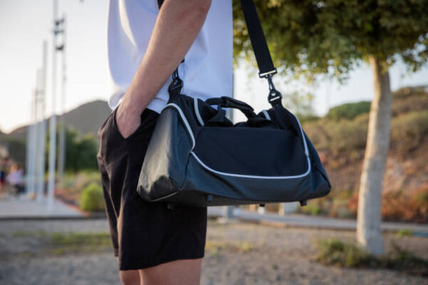 Close up of a sportsman's training bag in an outdoor gym, photo with copy space